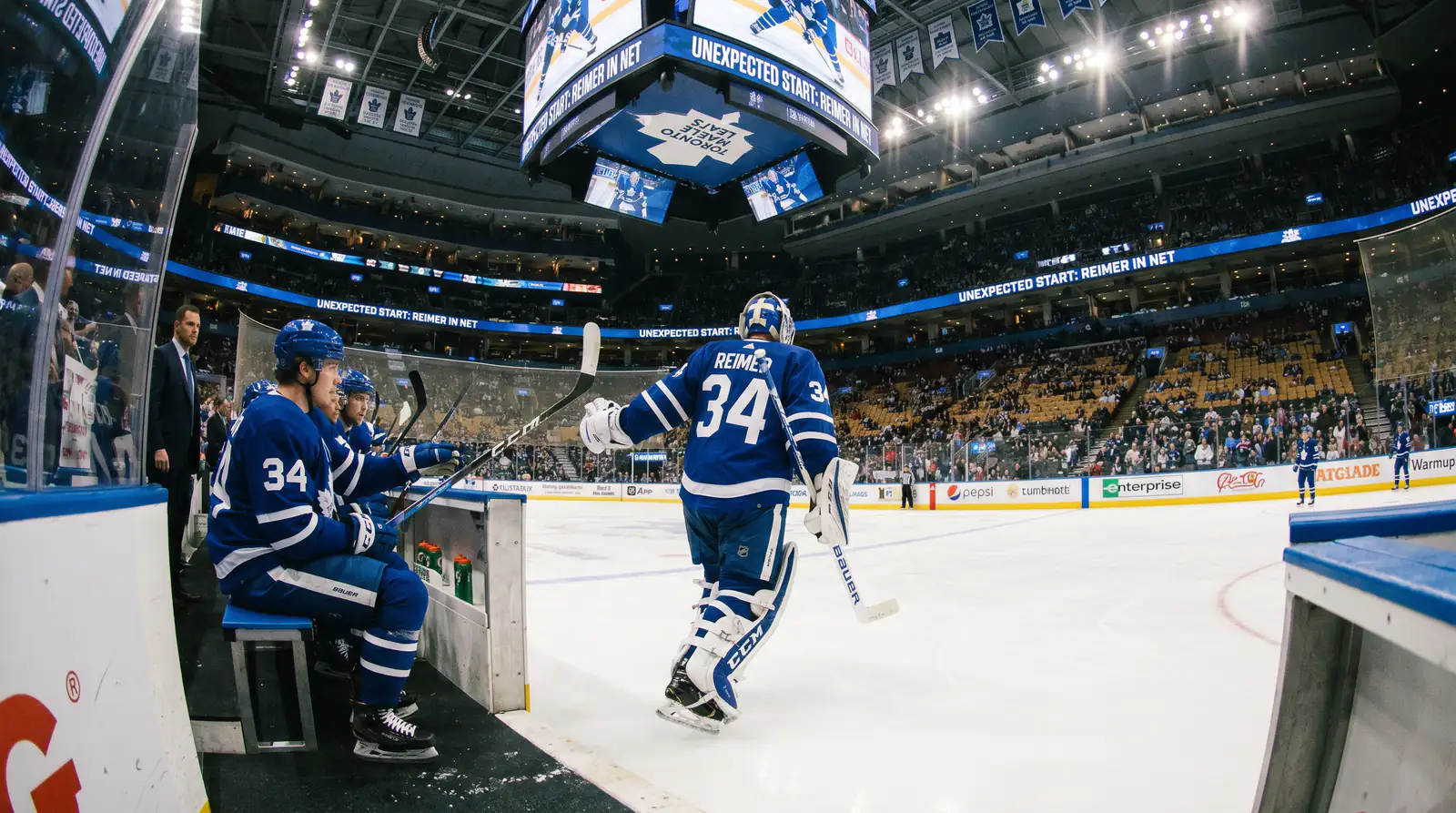 Backup goaltender skating onto the ice for an unexpected start in a packed NHL arena
