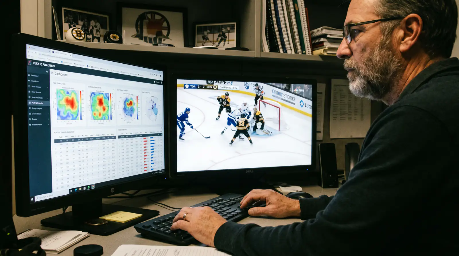 Analyst reviewing hockey advanced statistics on a dual-monitor setup
