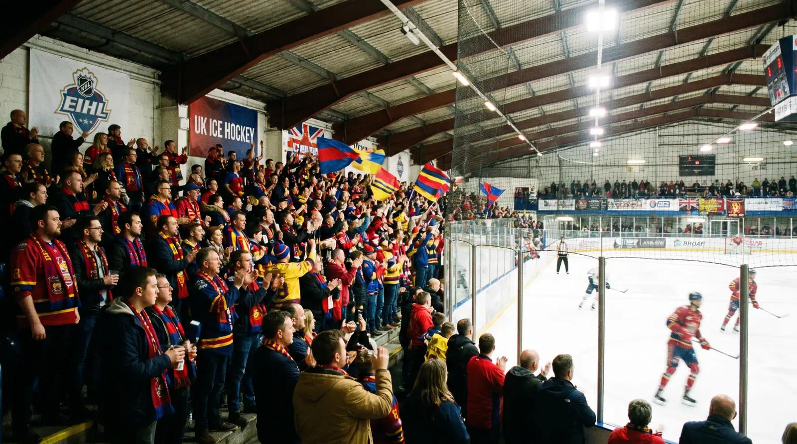 Packed UK ice hockey arena with enthusiastic EIHL fans creating strong home-ice atmosphere