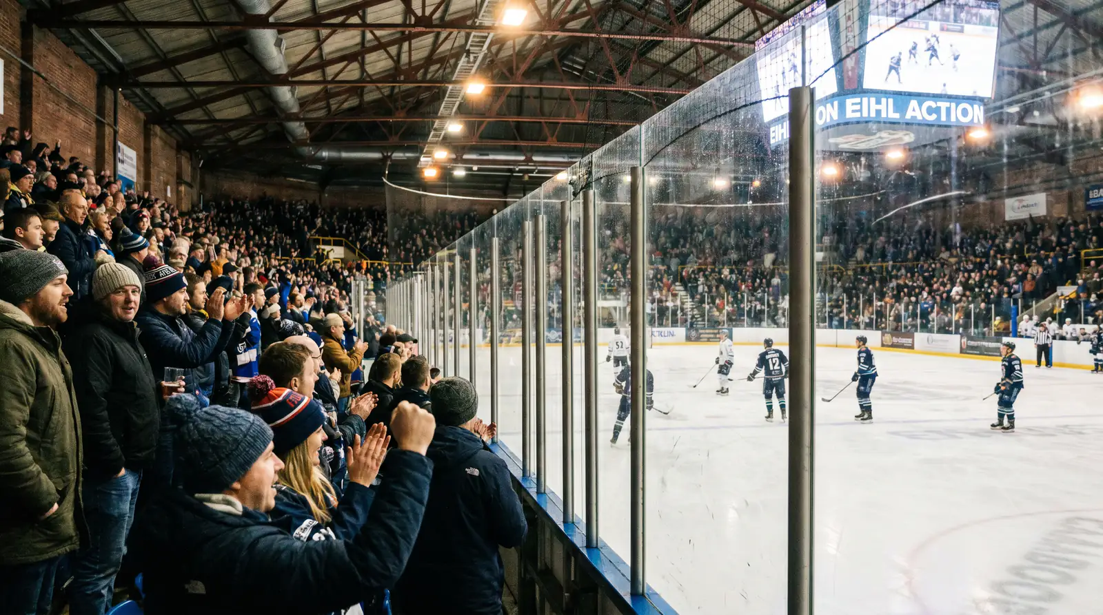 Packed EIHL ice hockey arena in the UK with fans cheering during a domestic league game