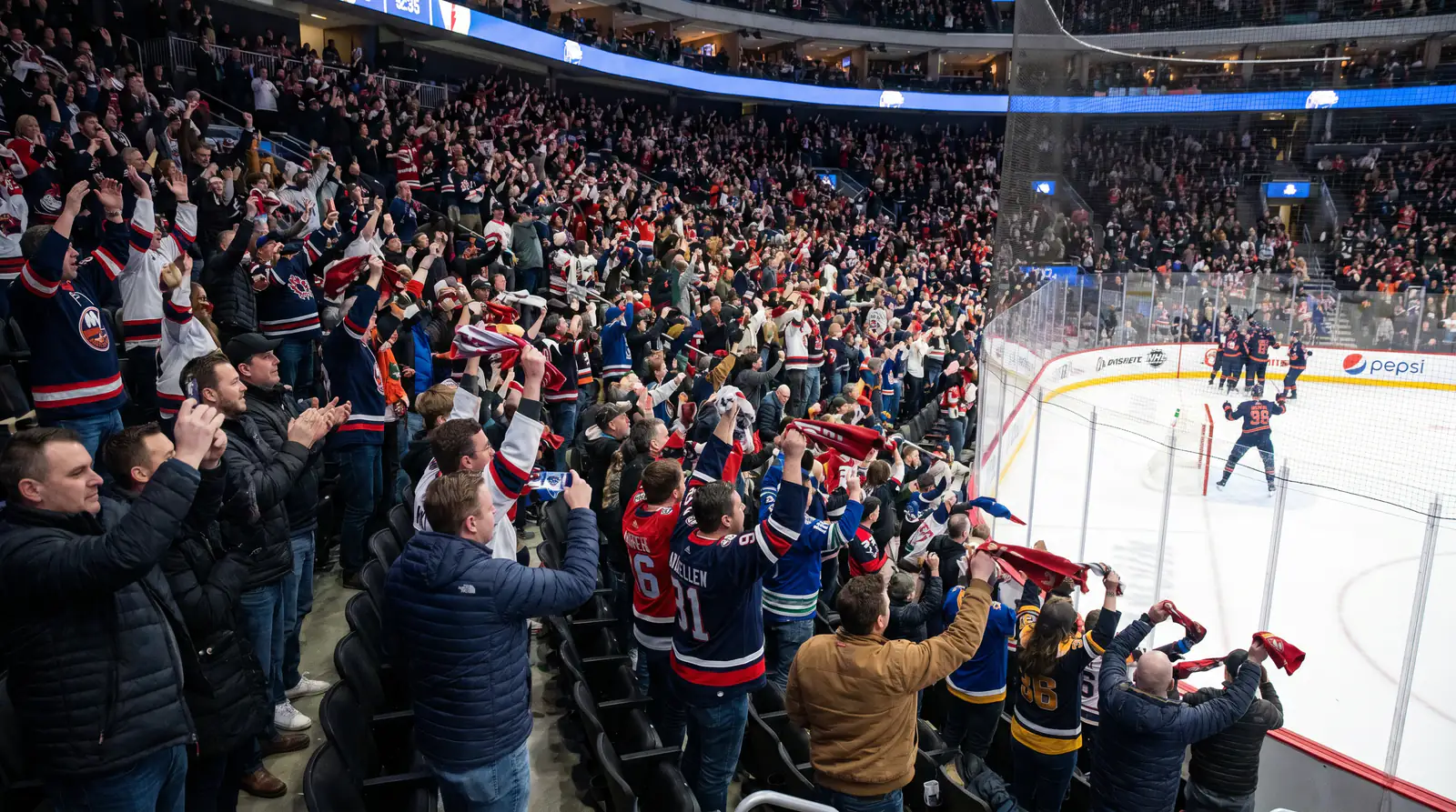 Hockey forward raising arms after scoring opening goal