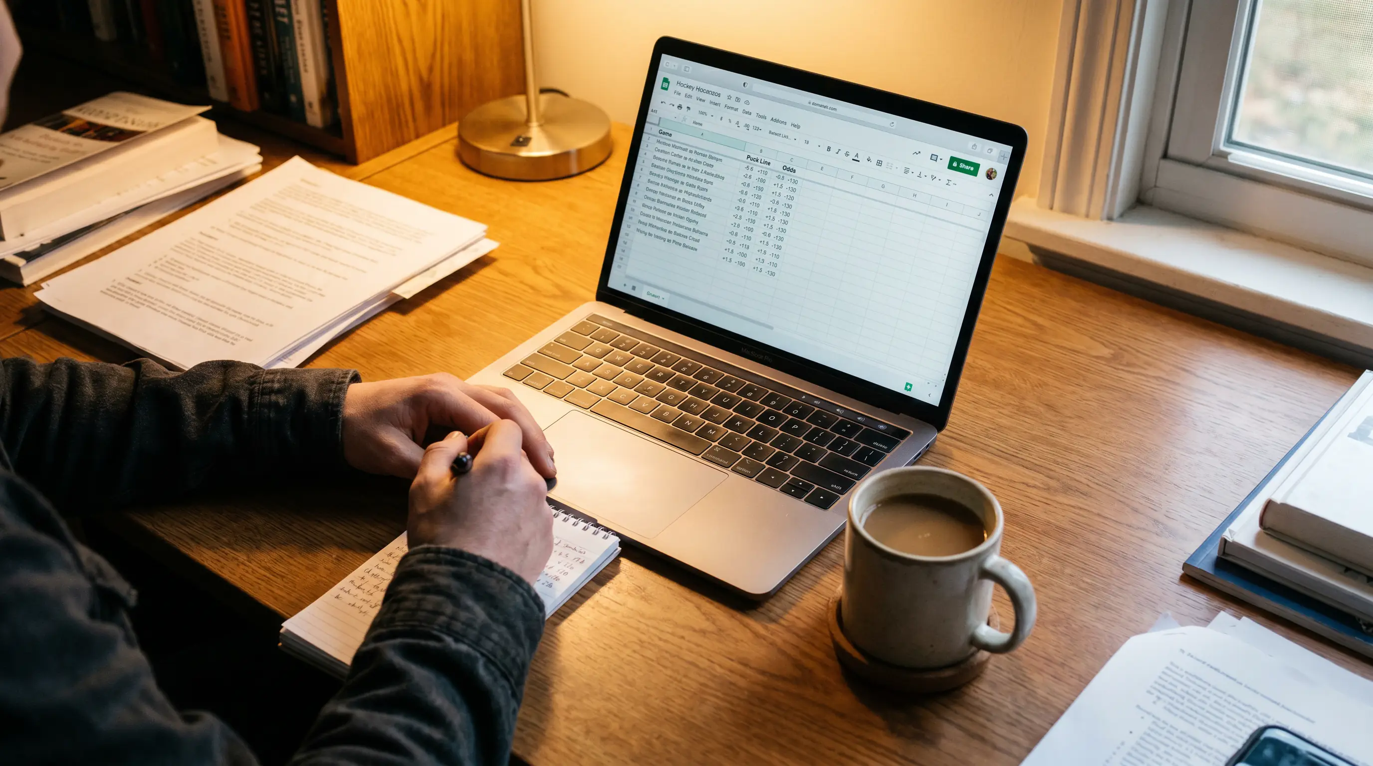 Hockey bettor reviewing puck line spread payouts on a laptop screen