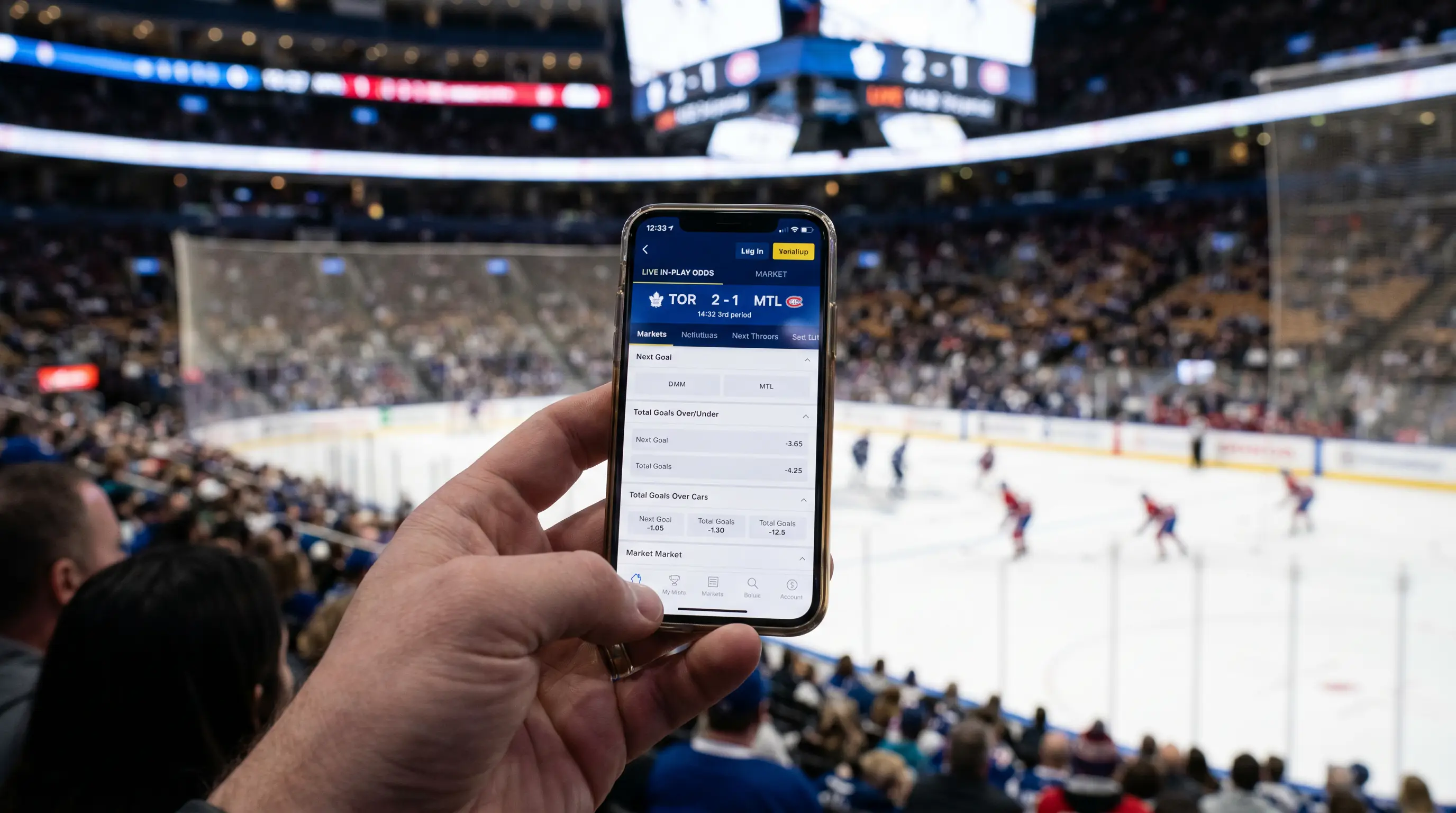 Person using a mobile betting app during a live hockey game showing in-play odds