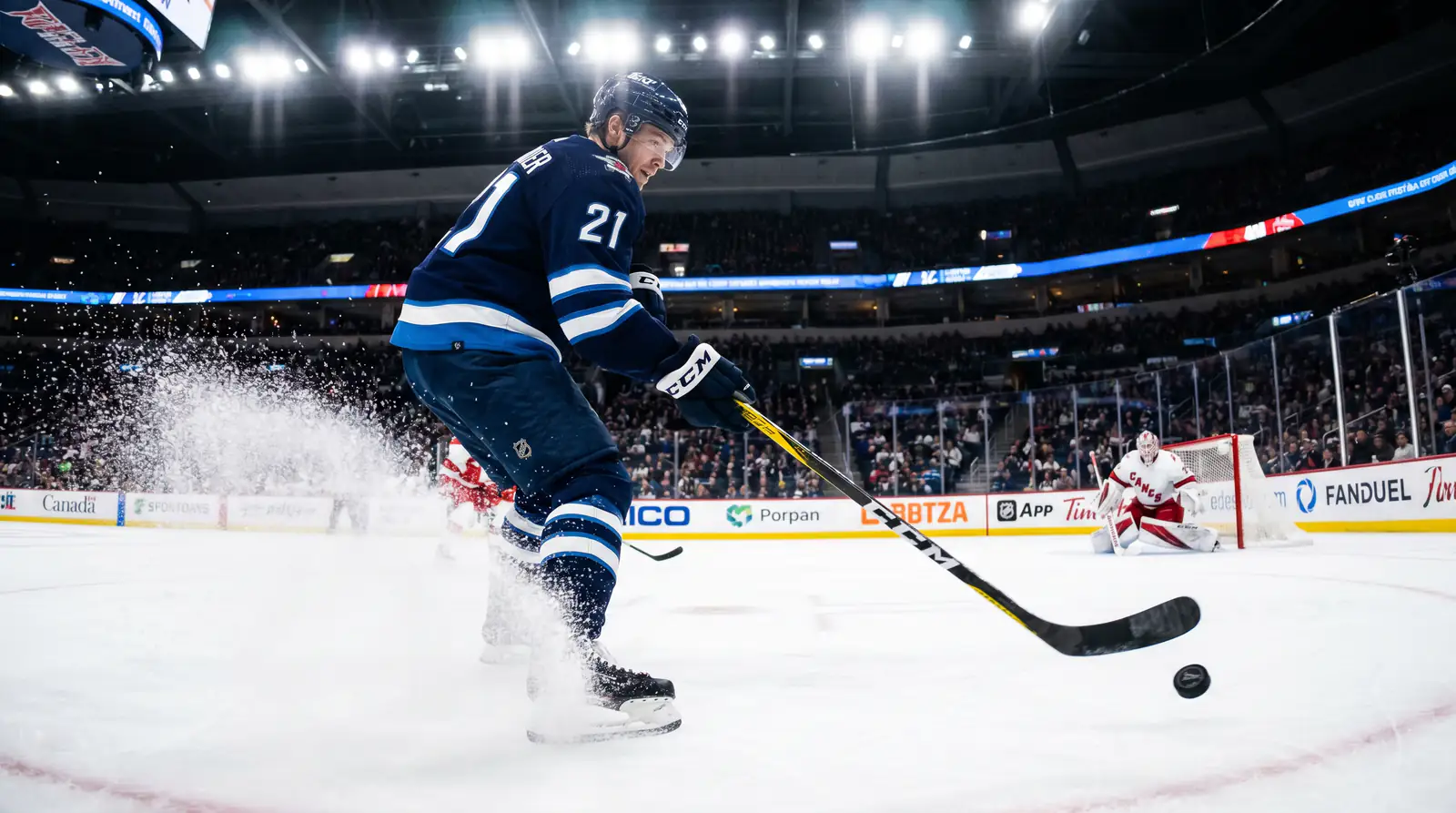 NHL forward taking a slap shot from the top of the circle during a game